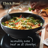 Wok with stir fry noodles. Text reads: Thick base provides incredibly even heat on all stovetops.
